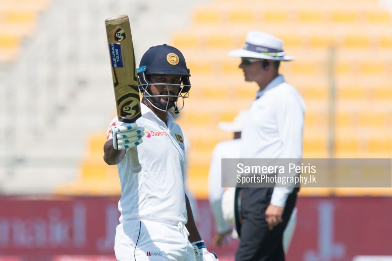 Dimuth Karunarathne rasing his bat to team mates after reaching his half century during the day 1 in 1st Test, between Sri Lanka Vs Pakistan held at Sheikh Zayed Cricket Stadium Abu Dhabi on 06th October 2017.